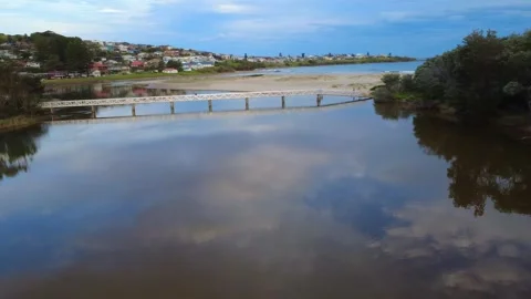 Reflective River Flowing to Ocean Stock Footage 331623969