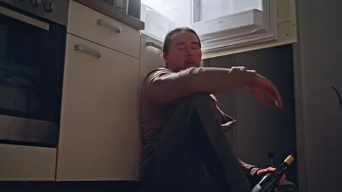 A Reflective Solo Moment in the Kitchen, capturing the essence of solitude and Stock Footage 309250937