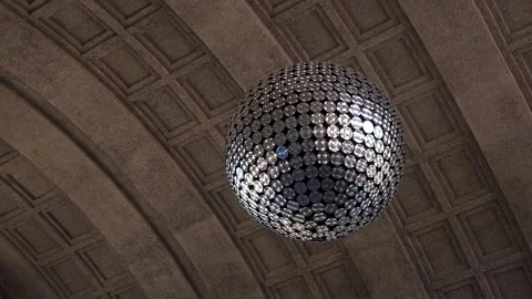 Reflective Sphere Sculpture Under Arched Ceiling in Zurich Train Station Stock Footage 338276191