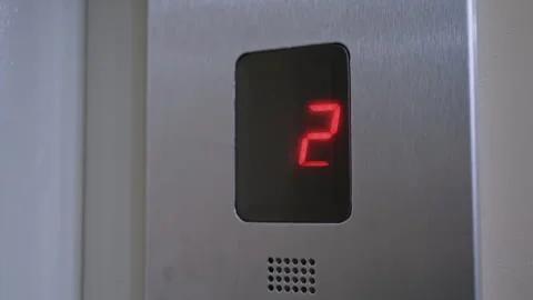 Reflective stainless steel panel displays descending digit changes. Detailed Stock Footage 334718136