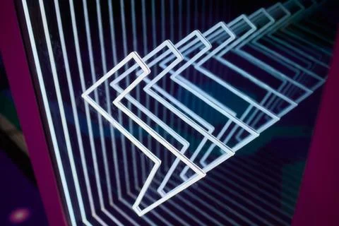 Reflective surface with layered chevron patterns in vibrant colors. Mood Stock Photos