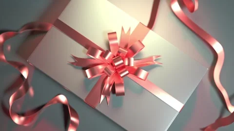 A reflective surface showcases a sparkling gift box with a delicate bow, su.. Video stock 294325408
