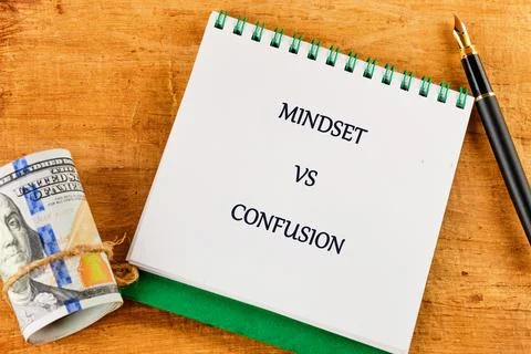 Reflective thoughts about personal growth are captured on paper while money s Stock Photos