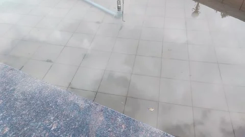Reflective tiled surface and building details viewed from a moving elevated Stock Footage 347527162