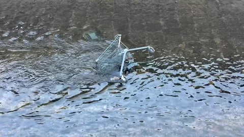 A Reflective Water Surface Capturing a Submerged Object Beneath the Calm Waves Stock Footage 303757532