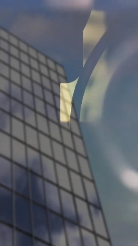 Reflective windows on skyscraper with clock and gears animation in background Stock Footage 341956896