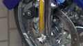 Reflector on bike wheel, motorcycle handlebars with raindrops, trade show HD Footage
