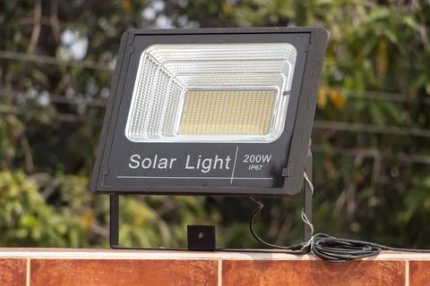 Reflector powered by solar panels fixed on the wall. Stock Photos