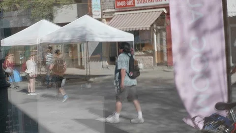Reflexion of people walking in a store window. Stock Footage 100471481