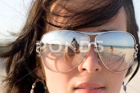 Reflexion of the photographer in model glasses Stock Photos