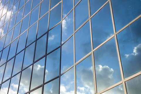 Reflexions of clouds and  sky in facade of modern building Stock Photos