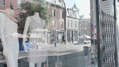 Reflexions of people walking in front of a store window. Stock Footage 100471405