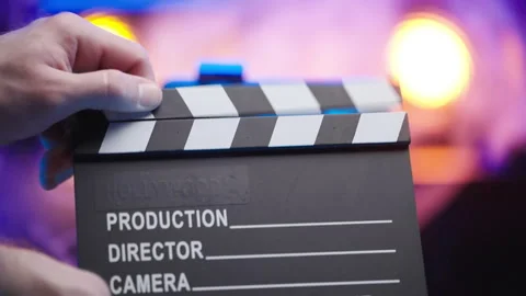 Refocus from clapping clapperboard to iPhone 15 Pro Max on Tripod 4K Stock Footage 260064767