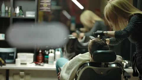 Refocusing from barber with client to open nameplate Stock Footage 134465802