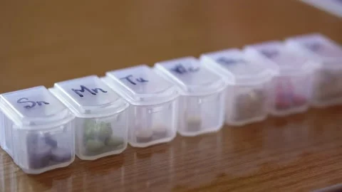 Refocusing from close to distant of plastic organizer box for pills with cells Stock Footage 152265836