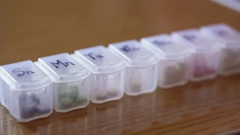 Refocusing from close to distant of plastic organizer box for pills with cells Stock Footage 153242877