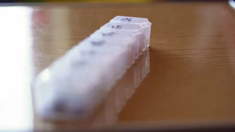 Refocusing from distant to near of plastic organizer box for pills with cells Stock Footage 152538988