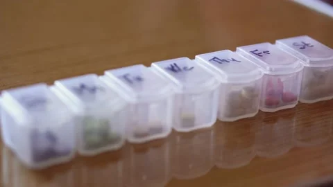 Refocusing from distant to near of plastic organizer box for pills with cells Stock Footage 153822543