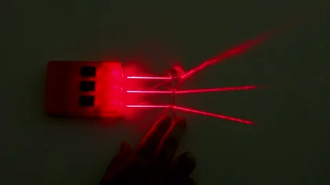 Refraction of Red Laser Beams Through Concave Lens in Physics Experiment Stock Footage 347336801