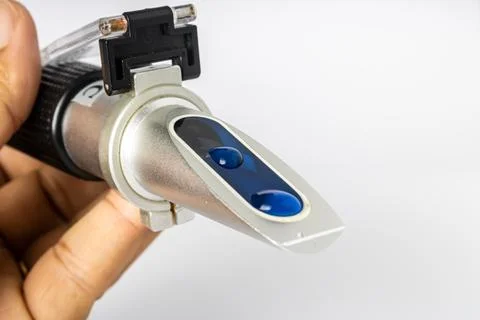 Refractometer used to measure the salinity level in marine aquarium water. Stock Photos