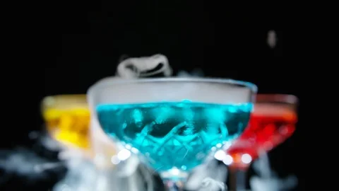 Refreshing alcoholic drinks with smoke  vapour pouring down the glass. Festive c 스톡 동영상 117699182
