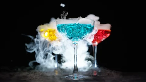 Refreshing alcoholic drinks with smoke  vapour pouring down the glass Stock Footage 117699838