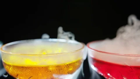 Refreshing alcoholic drinks with smoke  vapour pouring down the glass. Festive c Stock-Footage 117700997