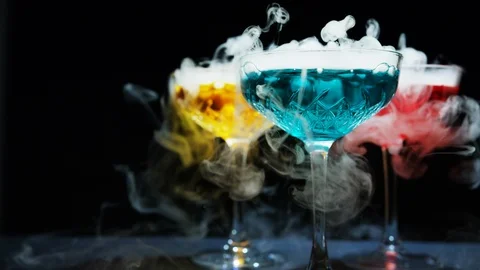 Refreshing alcoholic drinks with smoke  vapour pouring down the glass. Festive c 스톡 동영상 117706726