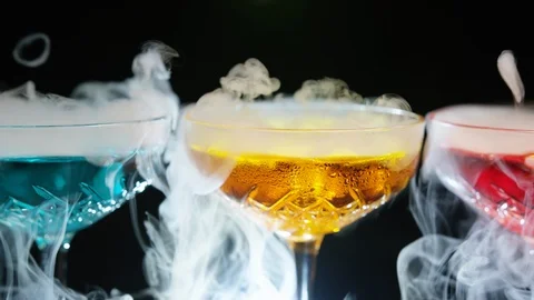 Refreshing alcoholic drinks with smoke  vapour pouring down the glass. Festive c Stock-Footage 117786881