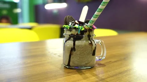 A refreshing and creamy milkshake with vanilla ice cream, chocolate, Oreo c.. 스톡 동영상 248166089