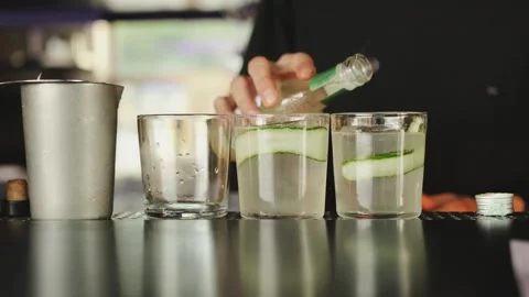 Refreshing and delicious Cucumber Drinks are being expertly prepared by Stock Footage 318065238