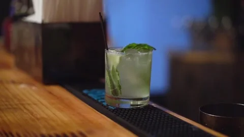 A Refreshing and Invigorating Cocktail with Mint and Lime on the Bar Counter Stock Footage 290933236