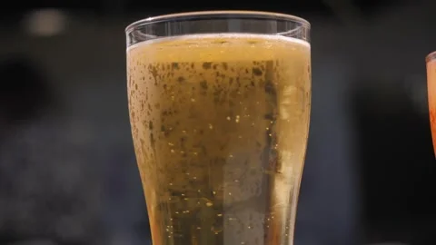 A Refreshing and Invigorating Glass of Beer with Bubbles in a Cozy and Inviting Stock Footage 292963384