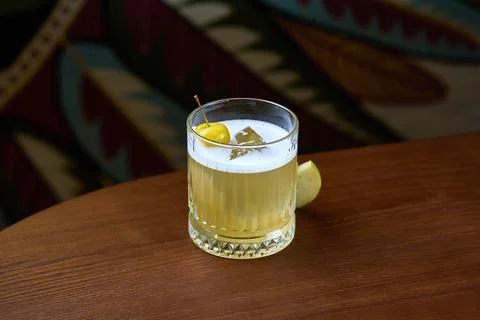 Refreshing Apple Cocktail with Cherry Garnish in a Glass on Wooden Table Stock Photos