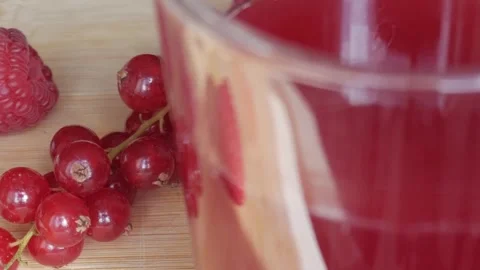Refreshing Berry Milkshake with Fresh Raspberries and Currants on Wooden Surface Stock Footage 334581937