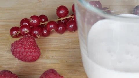 Refreshing Berry Milkshake with Fresh Raspberries and Redcurrants Stock Footage 334582643