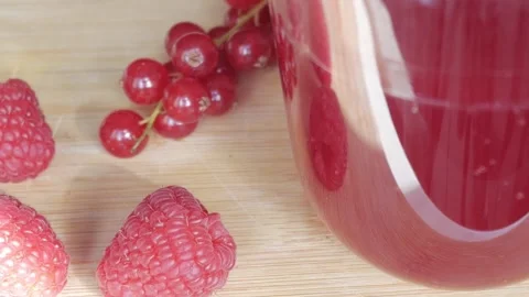 Refreshing Berry Milkshake with Fresh Raspberries and Currants on Wooden Board Stock Footage 334582649