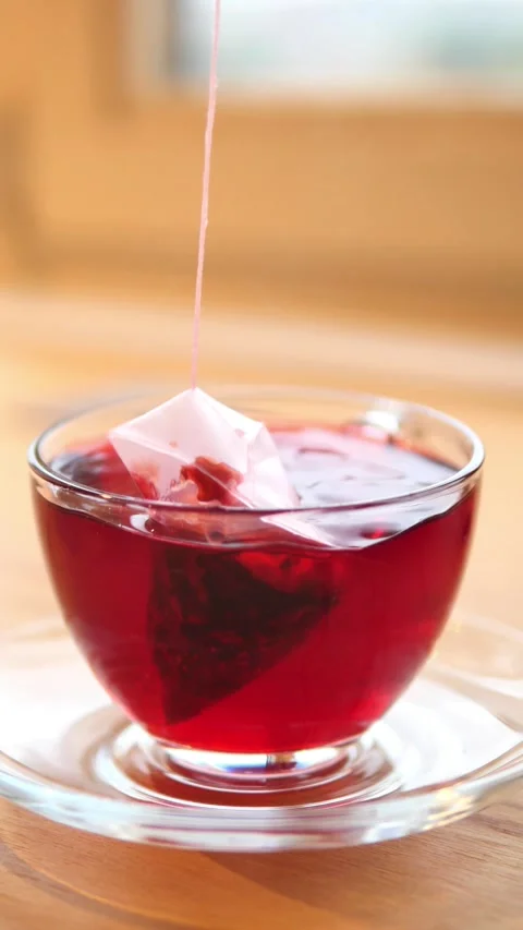 Refreshing berry tea with ice cube melting slowly Stock Footage 322557473