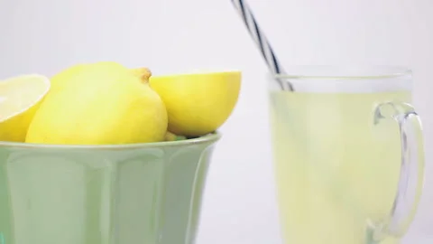 Refreshing Beverage - Jar Of Lemon Juice With Pile Lemons On Foreground (Looped) Video stock 112158169