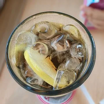 Refreshing Beverage with Lemon Slice and Ice Cubes in a Glass Stock Photos