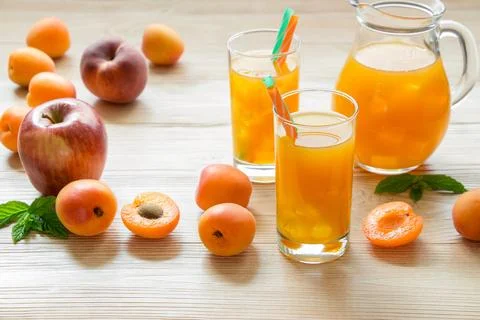 Refreshing beverage made from a blend of fresh apricot, apple, and peach served Stock Photos
