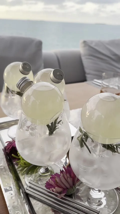 Refreshing beverage pour sequence by the ocean on a sunny day Stock Footage 318045057