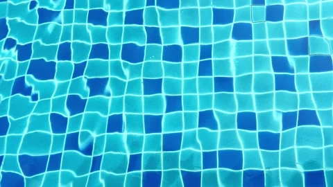 Refreshing blue water shimmers in the sunlight at a serene swimming pool on a Stock Footage 304881466