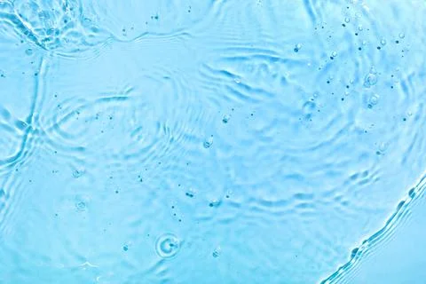 Refreshing blue water surface with ripples and air bubbles, clean liquid text Stock Photos