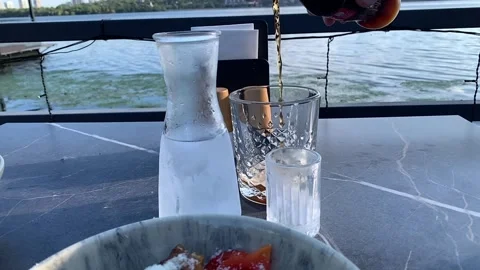 Refreshing Carbonated Beverage Served on a Riverfront Terrace Stock Footage 340052533