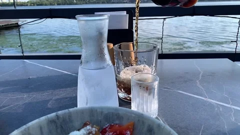 Refreshing Carbonated Beverage Served on a Riverfront Terrace Vídeos de archivo 340052539