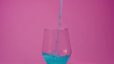 A refreshing carbonated drink is poured into a clear glass, bubbles are visible Stock Footage 247438215