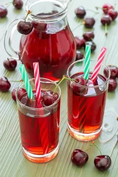 Refreshing cherry drink served in glasses with colorful straws accompanied by a Stock Photos