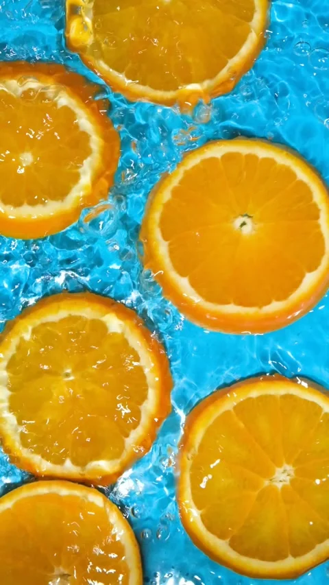 Refreshing citrus background with water moving over bright orange slices Stock Footage 338397529