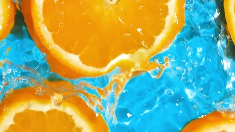 Refreshing citrus background with water moving over bright orange slices. Stock Footage 340168077